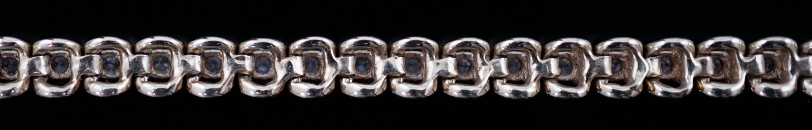 A modern 9ct gold and diamond chip set line bracelet